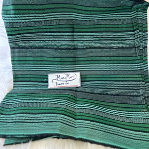 May include: Green and black striped fabric with a small white tag that says "Mamaw's Vintage Treasures" and a website address.