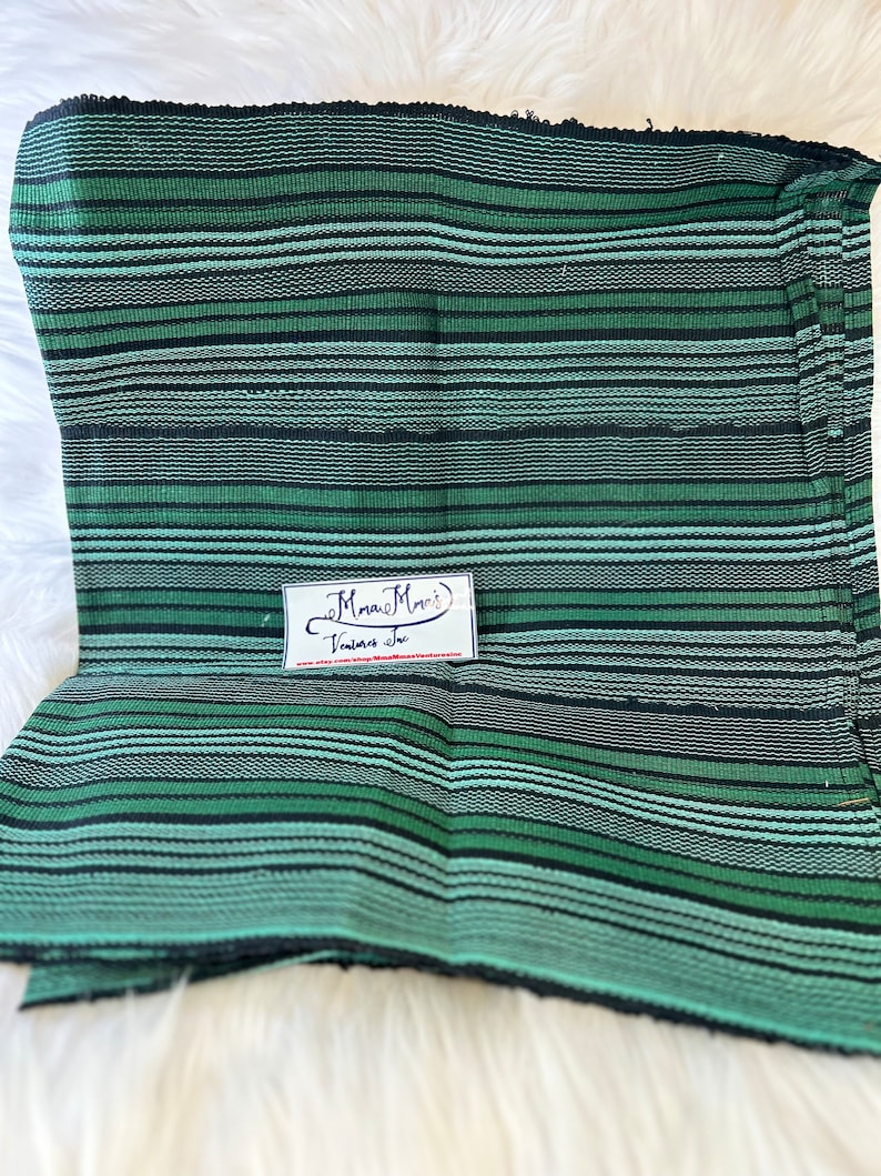 May include: Green and black striped fabric with a small white tag that says "Mamaw's Vintage Treasures" and a website address.