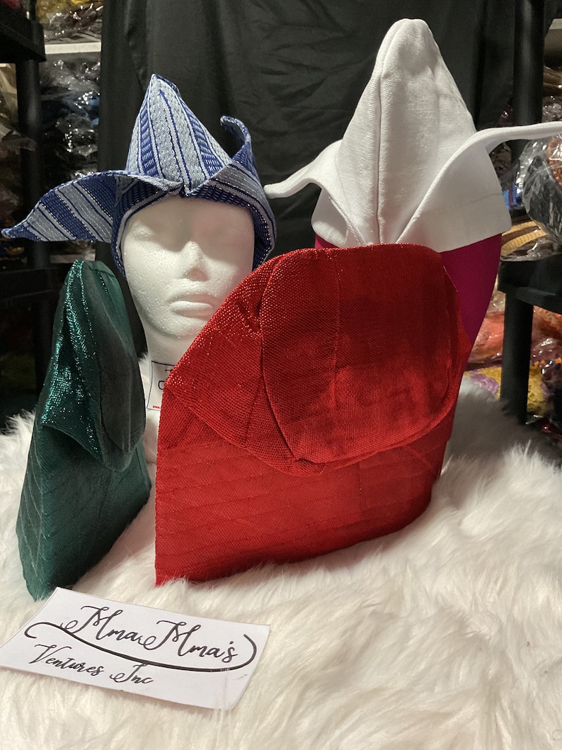 May include: An assortment of colorful, textured hats in various designs. The hats include a blue and white striped hat, a white hat with pink accents, a red hat, and a green hat. The hats are displayed on a white surface.