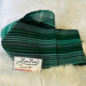 May include: Green and black striped fabric with a tag that reads "Mmau Mrai's Ventures Inc. www.etsy.com/shop/mmaumrai"