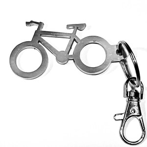 May include: A silver bicycle keychain with a split ring and a lobster clasp.