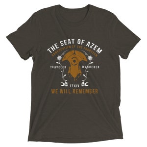 May include: A dark gray t-shirt with a brown graphic design featuring a stylized image of a helmet with the text "The Seat of Azem, Convocation of the Fourteen, Traveler, Wanderer, FFXIV, We Will Remember".