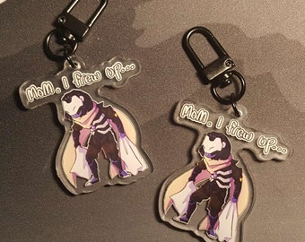 May include: Two clear acrylic keychains with black hardware. Each keychain features a cartoon character in a dark outfit with a light-colored cape and the text "Mom, I threw up..." in a speech bubble.