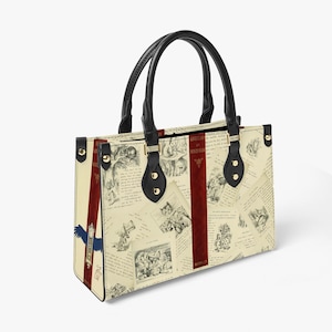 May include: A white and black tote bag with a red and gold stripe. The bag is covered in images from the book "Alice's Adventures in Wonderland".
