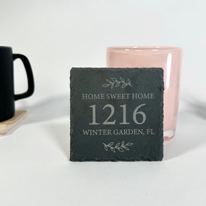 May include: Black slate house number sign with the text "Home Sweet Home", the number "1216", and "Winter Garden, FL".