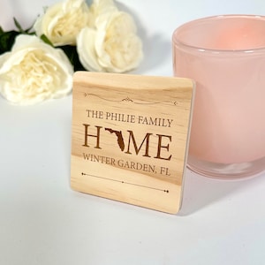 Op de afbeelding: Een houten bord met de tekst "The Philie Family Home" met een omtrek van de staat Florida in het midden van het woord "Home". Het bord heeft ook de tekst "Winter Garden, FL" onderaan.