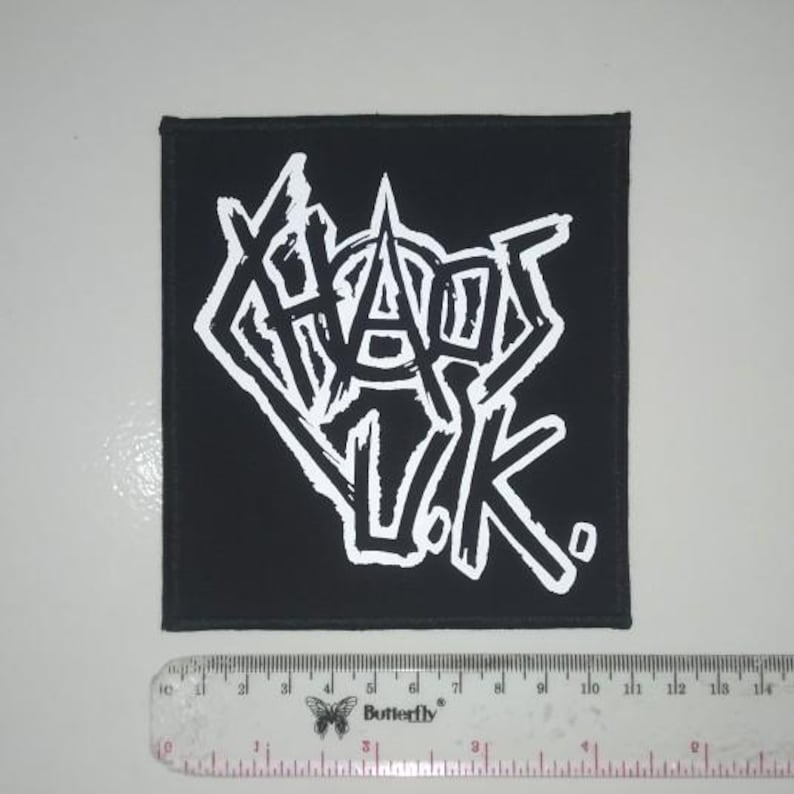 May include: Black fabric patch with white lettering that reads "Chaos UK".