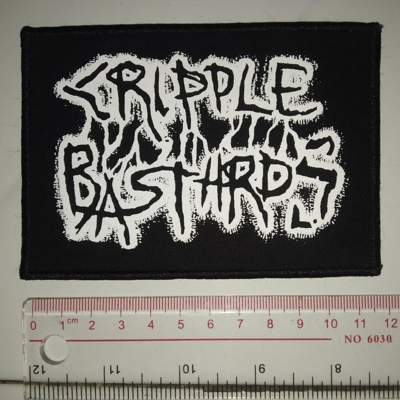 May include: Black and white embroidered patch with the text "CRIPPLE BASTARDS" in a stylised font.