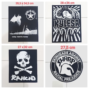May include: Four black patches with white graphics. One patch features a skull and crossbones with the word "Rancid". Another has a star and text. A third patch has a skull design with the word "KYLESA". The last patch has the text "Skinheads Against Racial Prejudice".