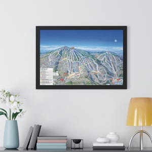 May include: A framed map of a ski resort with a detailed illustration of the mountain terrain and ski runs. The map is titled "Trail Map" and includes a legend with different colored lines representing different levels of difficulty.