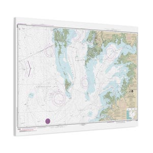 May include: A nautical chart of the Chesapeake Bay printed on a rectangular canvas. The map features light blue water, tan landmasses, and various navigational markings, depth soundings, and compass roses. Text includes Chesapeake Bay.