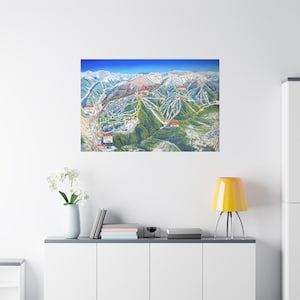 May include: A detailed map of a ski resort, showcasing the slopes, lifts, and surrounding mountain terrain. The artwork features a vibrant color palette with green, white, and blue hues, depicting the ski runs and infrastructure. The map is mounted on a canvas.