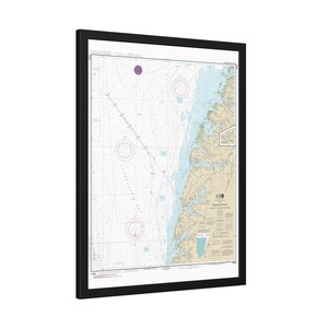 May include: A framed nautical chart of the Chesapeake Bay featuring detailed hydrographic data, depth soundings, and navigational markers. The map displays land in tan, water in light blue, and includes text labels for the Chesapeake Bay region.