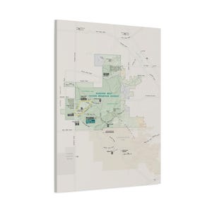 May include: A rectangular wall map print of the Saguaro West Tucson Mountain District. The map features a light beige background with a green shaded area representing the park, marked with roads, trails, and visitor centre locations in black.