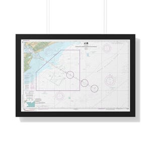 May include: A framed nautical chart titled Charleston Harbor Entrance and Approach, featuring detailed hydrographic data, depth soundings, navigational markers, and coastal topography in shades of blue, green, and tan within a black frame.