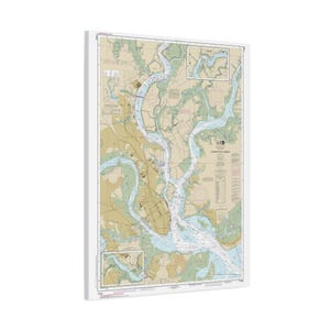 May include: A nautical chart of Charleston Harbor printed on a rectangular canvas. The map features light blue waterways, tan land masses, and various navigational markers, depth soundings, and text labels detailing the coastal geography.