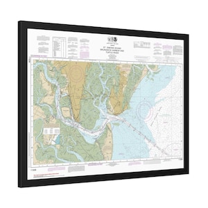 May include: Framed nautical chart of St. Simons Sound, Brunswick Harbor, and Turtle River. The chart features detailed depictions of waterways, landmasses, and depth soundings in feet. The map is framed in a black border.