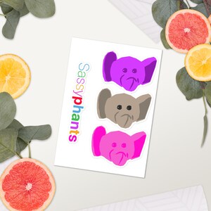 May include: Three colorful elephant stickers with the text "Sassyphants" in rainbow colors. The elephants are purple, gray, and pink.