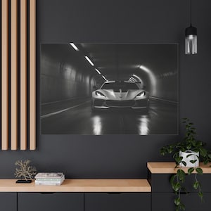 May include: A white sports car driving through a dark tunnel with bright lights at the end.