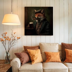 May include: A framed canvas print depicts a fox in a tweed cap and jacket, smoking a cigar and enjoying a pint of beer. The artwork has a vintage, pub-like aesthetic, with a dark green and brown color palette. The print is displayed above a beige sofa with orange and brown throw pillows.