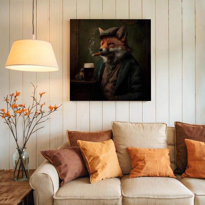 May include: A framed canvas print depicts a fox in a tweed cap and jacket, smoking a cigar and enjoying a pint of beer. The artwork has a vintage, pub-like aesthetic, with a dark green and brown color palette. The print is displayed above a beige sofa with orange and brown throw pillows.