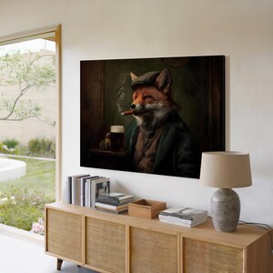 May include: A framed canvas art print depicts a fox in a tweed cap and green coat, smoking a cigar and holding a beer. The artwork has a vintage aesthetic, with a dark, moody color palette. The print is displayed above a wooden cabinet.