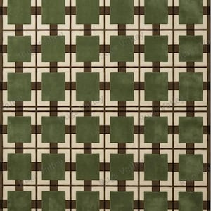 Könnte beinhalten: Ein rechteckiger Teppich mit geometrischem Muster. Er zeigt ein Rastermuster mit olivgrünen, cremefarbenen und dunkelbraunen Quadraten. Das symmetrische Layout und die Farbgebung des Teppichs eignen sich für moderne Innenräume.