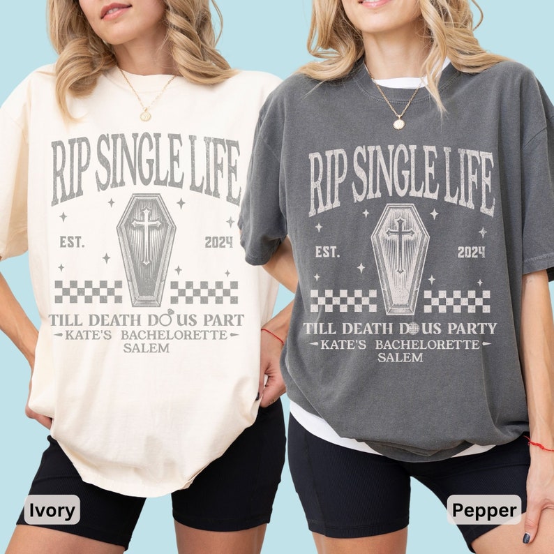 May include: Two oversized t-shirts, one cream and one grey, display the text "RIP SINGLE LIFE" above a coffin graphic. The shirts also include "EST. 2024" and "TILL DEATH DO US PART - KATE'S BACHELORETTE - SALEM".