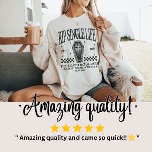 May include: A cream-coloured t-shirt featuring the text "RIP SINGLE LIFE" above a coffin graphic and the text "TILL DEATH DO US PART - KATE'S BACHELORETTE - SALEM". The shirt is themed for a bachelorette party.