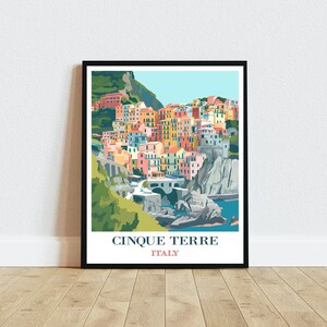 May include: A colourful illustration of the Cinque Terre region of Italy, featuring a hillside village with colourful buildings and a winding road leading to a bridge over the water. The text "Cinque Terre" and "Italy" is printed below the image.