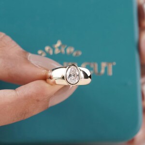 Oval diamond ring with modern bezel setting in gold