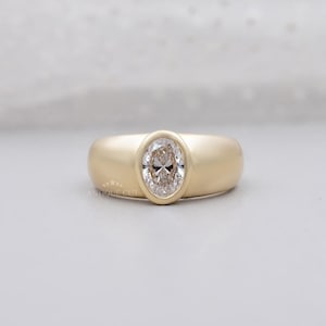 Oval lab created diamond engagement ring with bezel setting