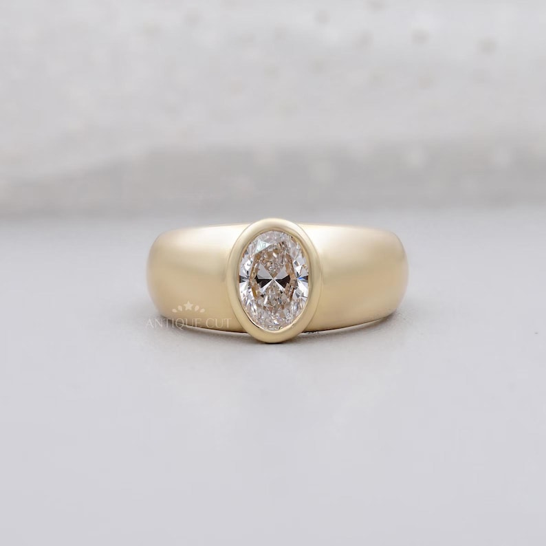 Oval lab created diamond engagement ring with bezel setting