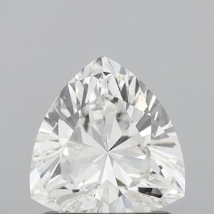 May include: A close-up of a brilliant-cut, colorless, triangular diamond. The gemstone has many facets that reflect light, creating a sparkling effect. The diamond is set against a neutral gray background.