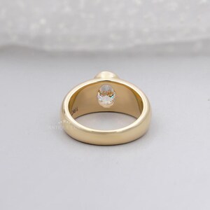Elegant oval engagement ring in yellow gold close up