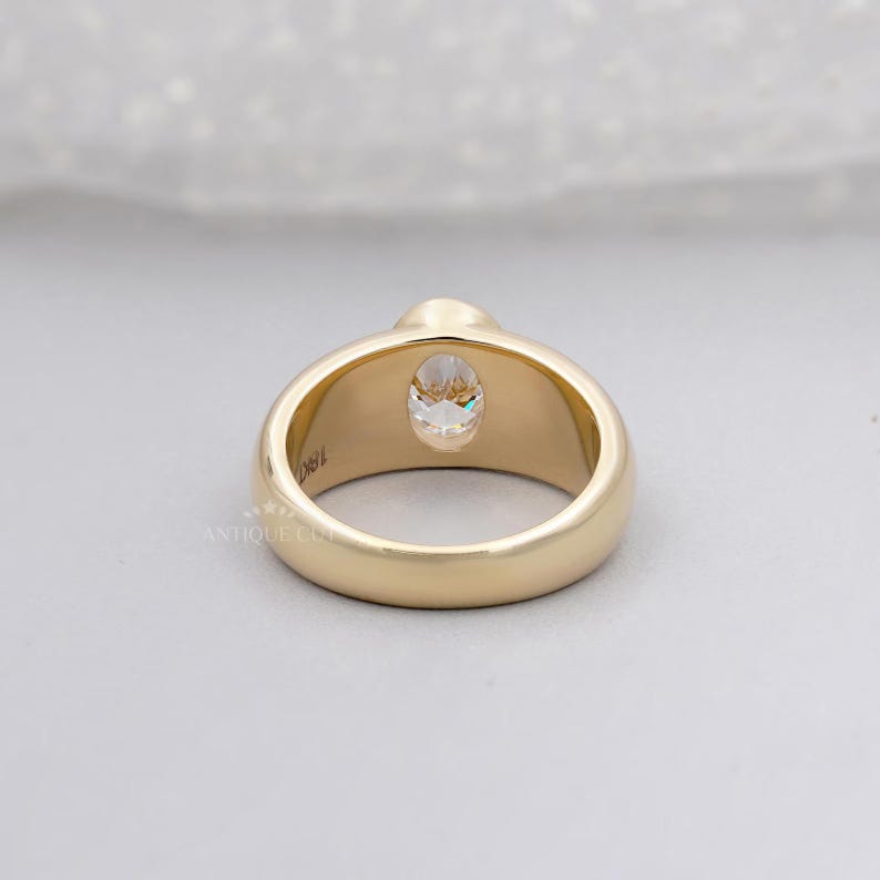 Elegant oval engagement ring in yellow gold close up