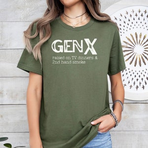 May include: A green t-shirt with the text "GENX raised on TV dinners & 2nd hand smoke" in white.