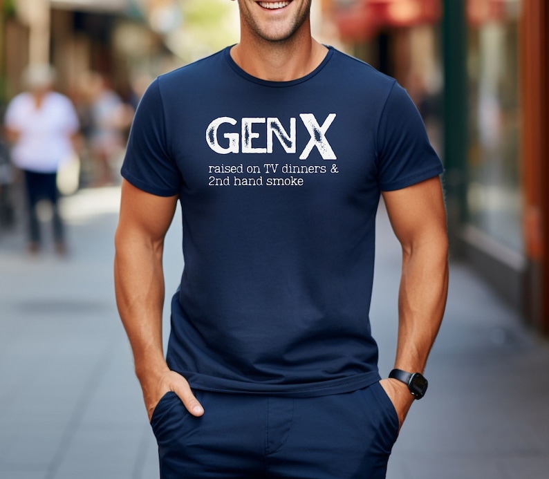 May include: A navy blue t-shirt with white text that reads "GENX raised on TV dinners & 2nd hand smoke".