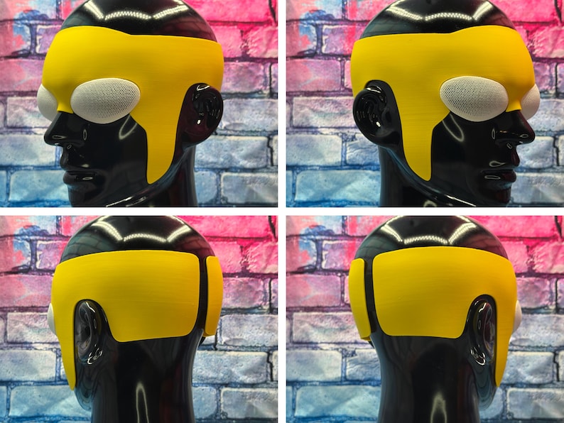 May include: A yellow headpiece featuring a smooth, solid-colored band that wraps around the forehead and sides, paired with white, oval-shaped mesh eye coverings. The accessory is displayed on a glossy black mannequin head from multiple angles.