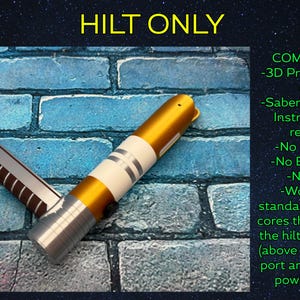 May include: A 3D-printed lightsaber hilt in gold, white, and silver, with the text "HILT ONLY." The hilt has a detailed design and is shown against a blue brick wall background. The image also includes text describing the product.