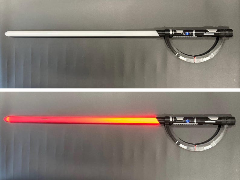 May include: A black and silver lightsaber with a white blade, and a second image with a red and orange blade. The hilt features detailed silver accents and a curved guard. The lightsaber is a prop or toy.