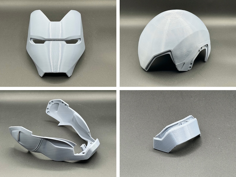 Puede incluir: Un casco de pl&aacute;stico gris impreso en 3D con una m&aacute;scara facial, una pieza superior y dos piezas laterales. El casco est&aacute; dise&ntilde;ado para parecer un casco futurista o de ciencia ficci&oacute;n.