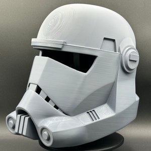 May include: A white plastic helmet with a detailed design, resembling a Star Wars Stormtrooper helmet.