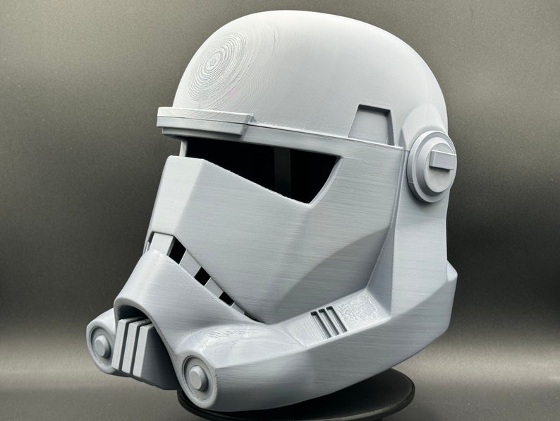May include: A white plastic helmet with a detailed design, resembling a Star Wars Stormtrooper helmet.