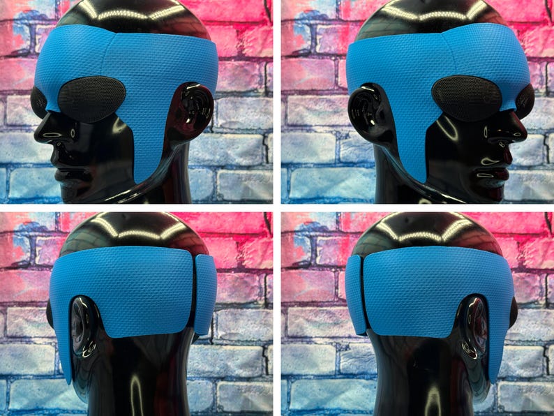 May include: A bright blue textured headband worn on a glossy black mannequin head. The headband features a wide, contoured design that wraps around the forehead and extends down to cover the ears, showcasing a consistent dimpled surface pattern.