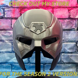 May include: A silver and gray helmet with a stylized bird emblem, displayed against a brick wall. The text "CHECK OUT MY STORE" and "FOR THE SEASON 2 VERSION!" are visible.