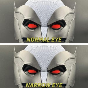 May include: A close-up of a gray mask with red eyes. The top image shows the mask with normal eyes, while the bottom image shows the mask with narrow eyes. The text "NORMAL EYE" is below the top image, and the text "NARROW EYE" is below the bottom image.