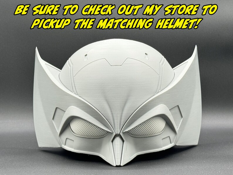 May include: A white plastic helmet with a textured surface and a black mesh visor. The helmet has a unique design with two large wings on the sides.