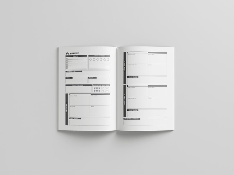 May include: Open, blank planner with black and white design. The left page has sections for daily tasks, mood, and focus. The right page has sections for tracking plans and reviews. The planner is open on a white surface.