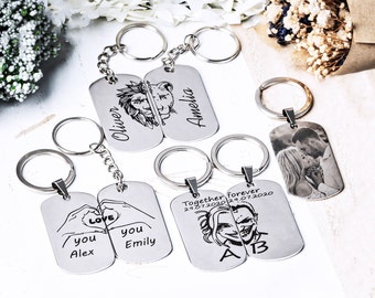 May include: A collection of silver-toned metal dog tag keychains featuring various custom engravings, including a lion and lioness, hands forming a heart with the names Alex and Emily, a couple, and characters with the text Together forever 24.07.2020.